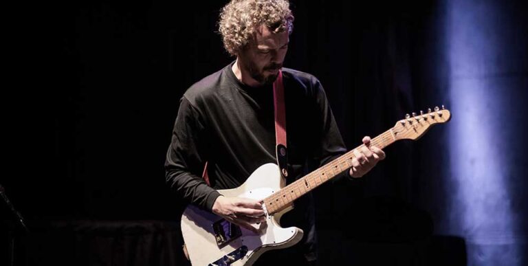 Colour photo of musician Jakob Bro playing guitar