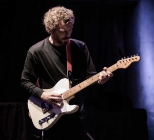 Colour photo of musician Jakob Bro playing guitar