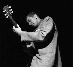 Black and white photograph of Kenny Burrell playing guitar by Francis Wolff.