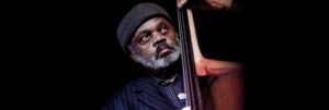 Colour portrait of Henry Grimes playing the double bass.