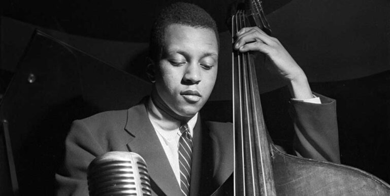 Black and white photograph by Francis Wolff of Doug Watkins playing the bass.