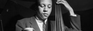 Black and white photograph by Francis Wolff of Doug Watkins playing the bass.