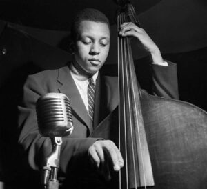 Black and white photograph by Francis Wolff of Doug Watkins playing the bass.